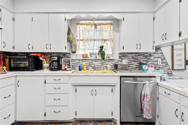 kitchen featuring decorative backsplash, dishwasher, white cabinets, and sink