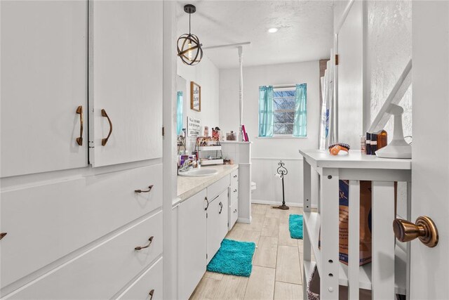 bathroom with toilet, a textured ceiling, and vanity