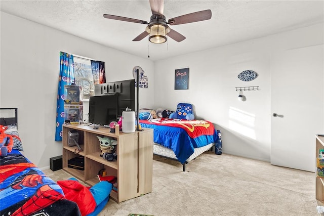 carpeted bedroom with a textured ceiling and ceiling fan