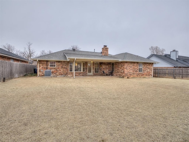 rear view of property featuring central AC