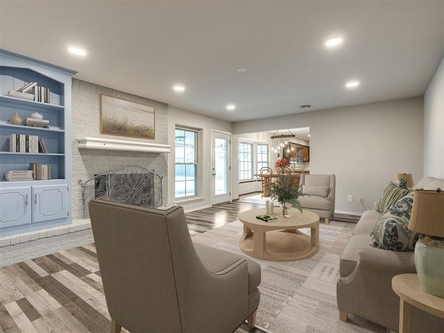 living room with a fireplace and light hardwood / wood-style flooring