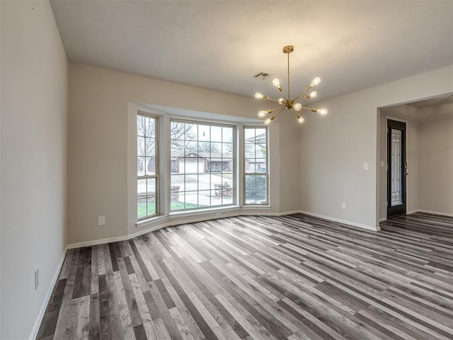 interior space with wood-type flooring and a chandelier