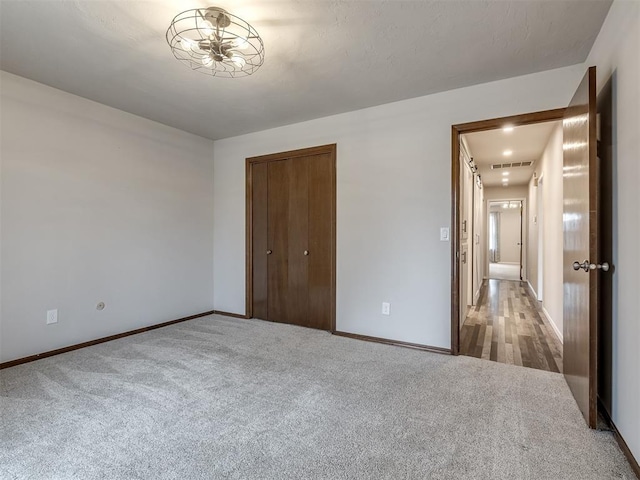 unfurnished bedroom with carpet flooring and a closet