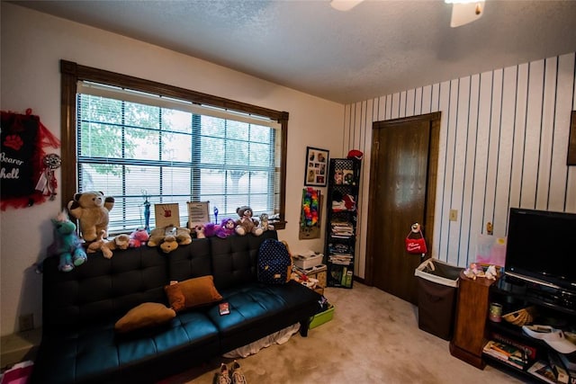 living room with a textured ceiling and light carpet