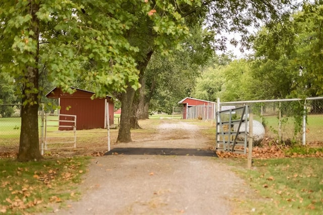 view of gate with an outdoor structure