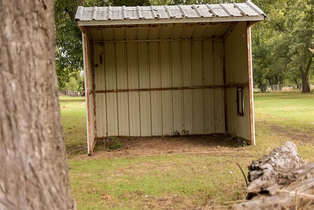 view of outbuilding featuring a lawn