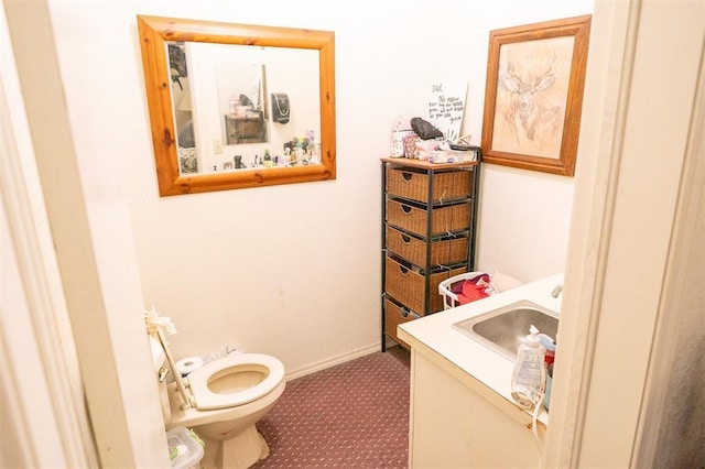 bathroom featuring toilet and vanity