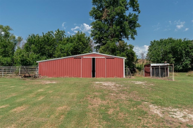 view of outdoor structure featuring a lawn