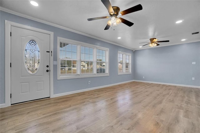 entrance foyer with ceiling fan, crown molding, and light hardwood / wood-style flooring