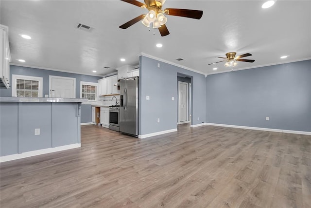 unfurnished living room with ceiling fan, crown molding, and light hardwood / wood-style flooring