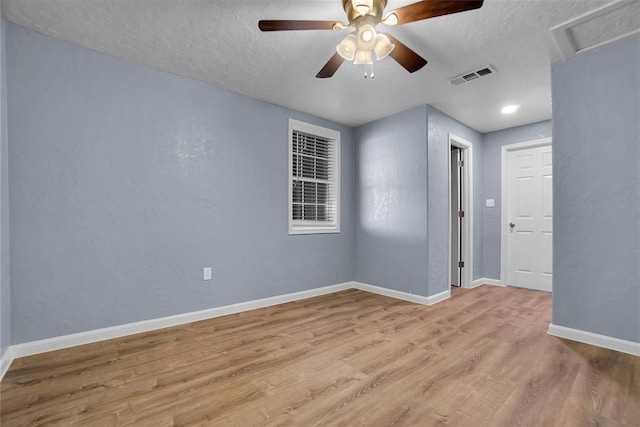 unfurnished room featuring ceiling fan, a textured ceiling, and light hardwood / wood-style flooring