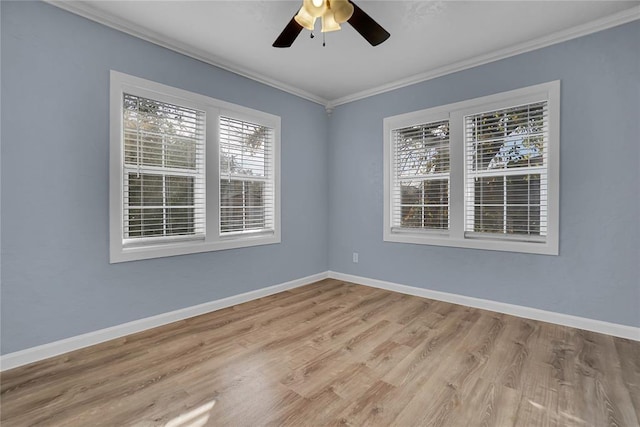 empty room with ceiling fan, ornamental molding, and light hardwood / wood-style floors