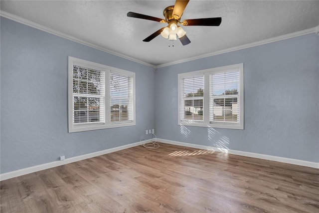 spare room with ceiling fan, ornamental molding, and hardwood / wood-style flooring