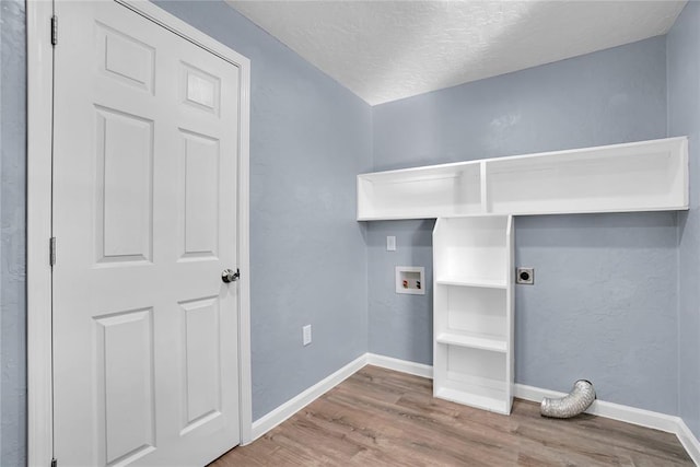 washroom featuring wood-type flooring, hookup for a washing machine, electric dryer hookup, and a textured ceiling