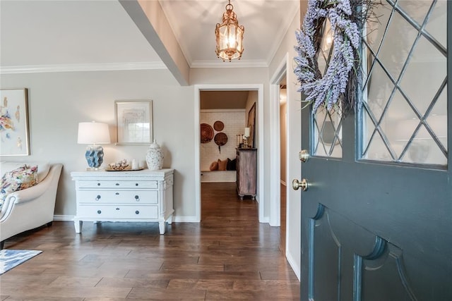 foyer entrance featuring dark wood-type flooring and ornamental molding