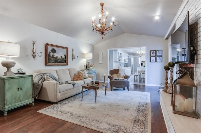 living room with wood-type flooring, a chandelier, and vaulted ceiling