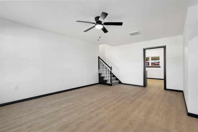 spare room with ceiling fan and light wood-type flooring