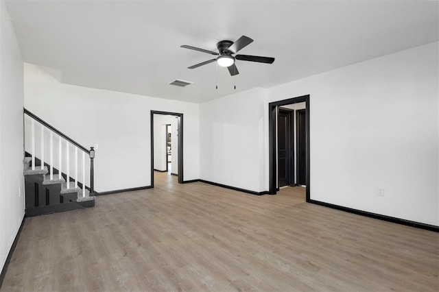 unfurnished living room featuring ceiling fan and light wood-type flooring