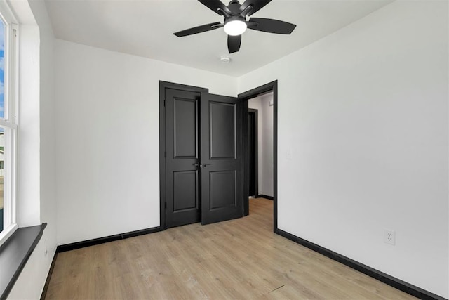 unfurnished bedroom with light wood-type flooring and ceiling fan