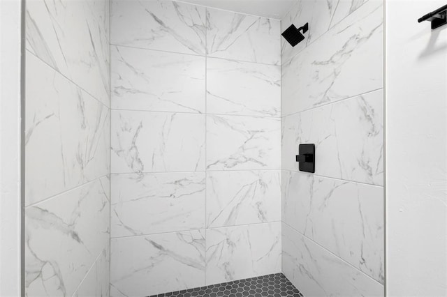 bathroom with tiled shower