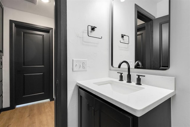 bathroom with hardwood / wood-style floors and vanity