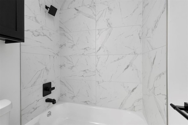 bathroom featuring toilet and tiled shower / bath combo