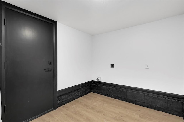 washroom featuring hardwood / wood-style flooring and hookup for an electric dryer