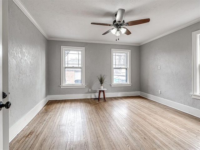 spare room featuring crown molding, a textured ceiling, ceiling fan, and light hardwood / wood-style floors