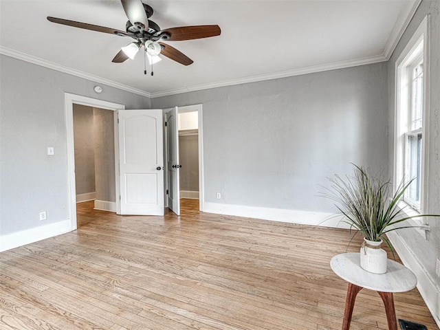 spare room with crown molding, ceiling fan, and light hardwood / wood-style flooring