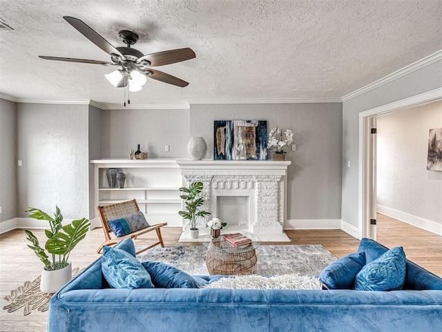 living room with crown molding, a textured ceiling, light hardwood / wood-style floors, and a fireplace