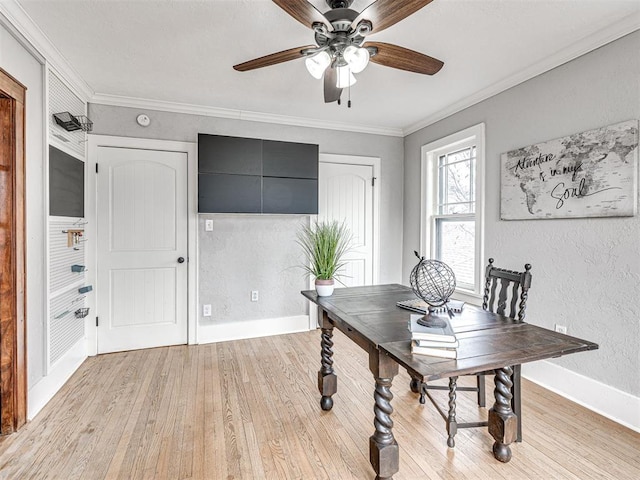 office area featuring ceiling fan, ornamental molding, and light hardwood / wood-style flooring