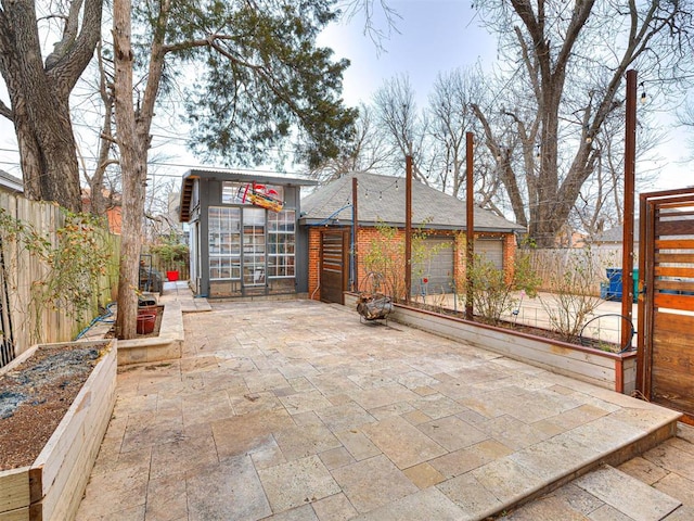 view of patio featuring a garage and an outdoor structure