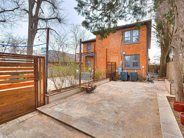 back of property featuring central AC unit and a patio