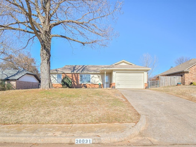 single story home with a garage and a front lawn