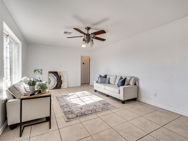 living room with ceiling fan and light tile patterned flooring