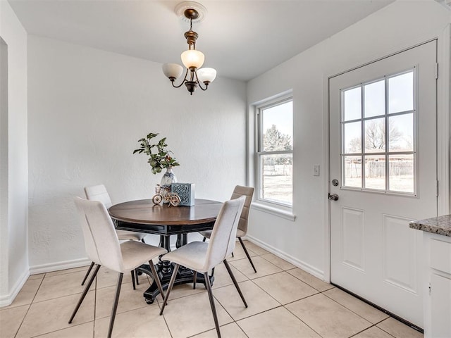 tiled dining area with a notable chandelier