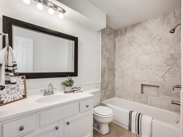 full bathroom with tiled shower / bath combo, toilet, tile patterned floors, and vanity