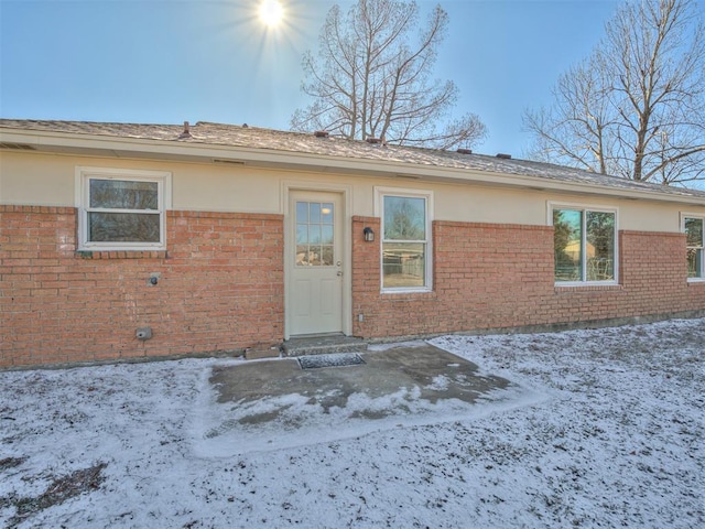 view of snow covered property entrance