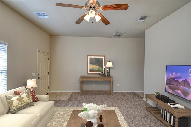 carpeted living room with ceiling fan