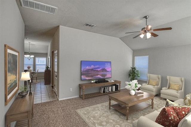 living room with light carpet, ceiling fan with notable chandelier, and lofted ceiling