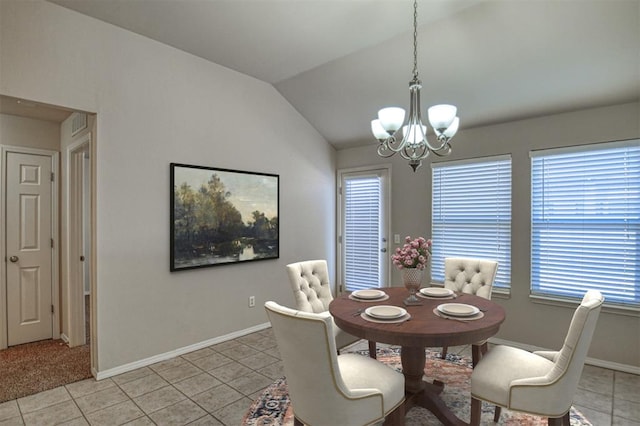 dining space featuring lofted ceiling, light tile patterned floors, and a notable chandelier