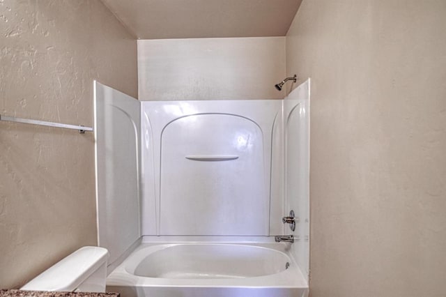 bathroom with shower / bathtub combination and toilet