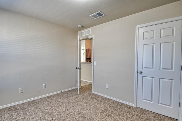 unfurnished bedroom with light colored carpet