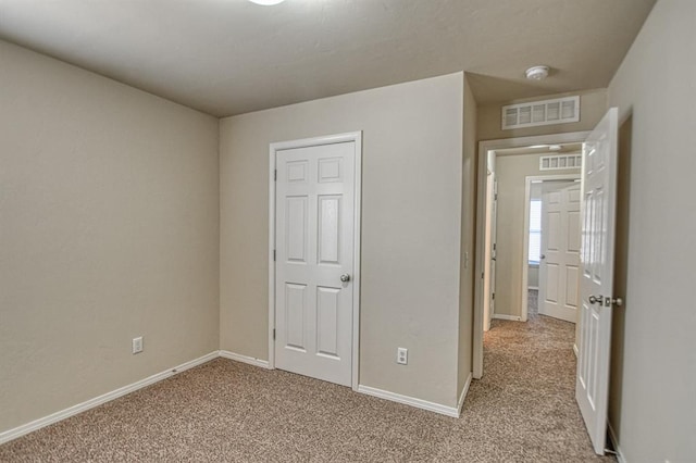 unfurnished bedroom with light carpet