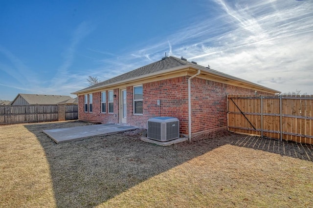 back of house featuring a patio area and central air condition unit