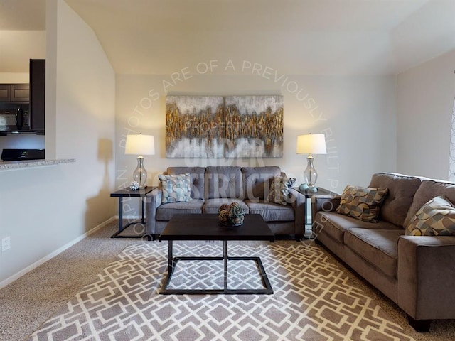 living room featuring carpet and vaulted ceiling