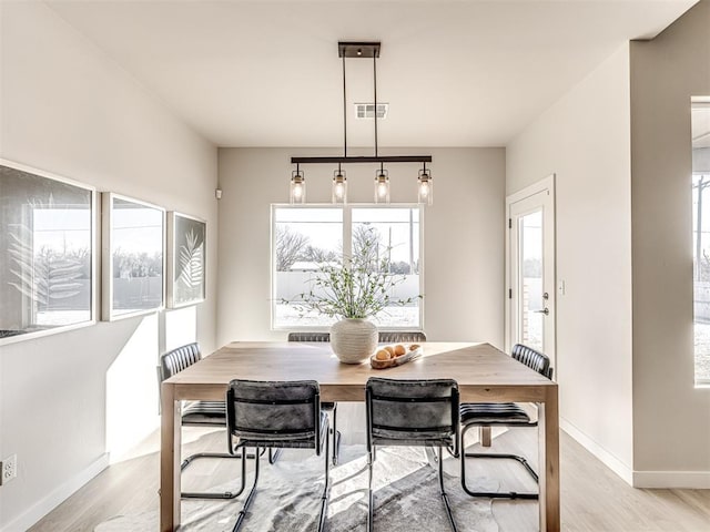 dining space with light hardwood / wood-style flooring