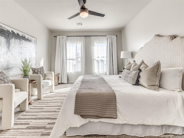 bedroom featuring ceiling fan and light carpet