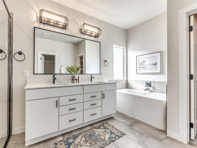 bathroom with vanity and a tub