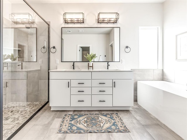 bathroom featuring vanity and shower with separate bathtub